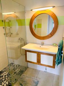 a bathroom with a sink and a mirror at Ruoms Petite Maison 3* centre-village in Ruoms