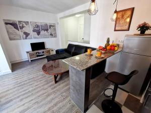 a kitchen and living room with a refrigerator and a table at Holiday Apartment Mariola in Calpe