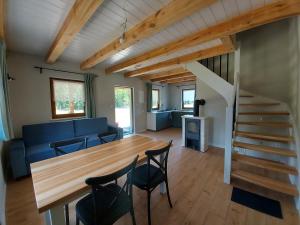 a living room with a wooden table and chairs at Domek u Beti 2 in Wąglikowice