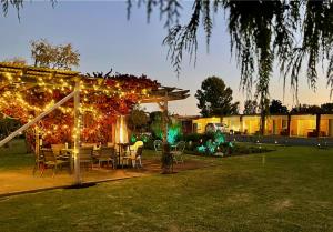a table and chairs under a pavilion with lights at Quirindi Sunflower Motor Inn in Quirindi