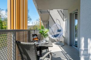 patio ze stołem i krzesłami na balkonie w obiekcie Exclusive Gold Apartment w Krakowie