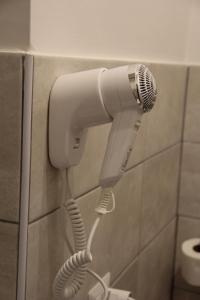 a blow dryer on a wall in a bathroom at Vite 99 spanish steps room in Rome