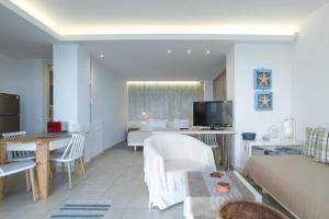 A television and/or entertainment centre at Junior suite by the beach Stalida