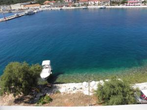 a boat sitting in the water near a harbor at Apartments Svetka - 10m from the sea in Sali