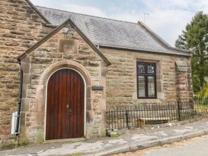 an old stone church with a wooden door at Andlestone in Matlock