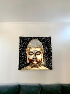 a picture of a gold head on a wall at Leo's city apartment in Lefkada