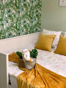 a stuffed animal sitting on top of a bed at Modern apartment with jacuzzi and city view, Almería, 80 m² in Almería