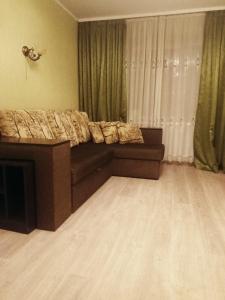 a living room with a bed and a couch at Apartment Chernihivska 13 in Shostka