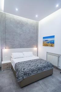 ein Schlafzimmer mit einem Bett und einem Wandgemälde in der Unterkunft Casa Nora Napoli in Neapel