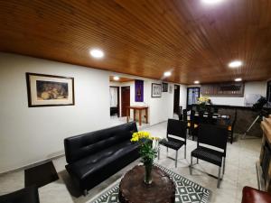 a living room with a couch and a table at Cabaña Campestre Katie in Paipa