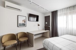 A television and/or entertainment centre at Exclusive Rooms in the Heart of the City
