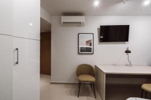 A television and/or entertainment centre at Exclusive Rooms in the Heart of the City