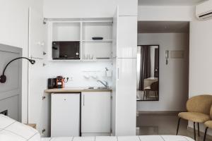 A kitchen or kitchenette at Exclusive Rooms in the Heart of the City
