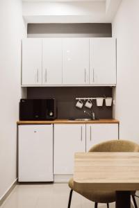 A kitchen or kitchenette at Exclusive Rooms in the Heart of the City