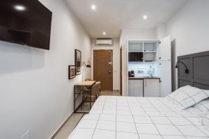 A kitchen or kitchenette at Exclusive Rooms in the Heart of the City