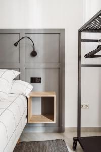 A bed or beds in a room at Exclusive Rooms in the Heart of the City