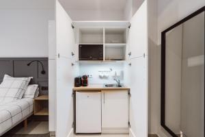 A kitchen or kitchenette at Exclusive Rooms in the Heart of the City