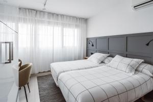A bed or beds in a room at Exclusive Rooms in the Heart of the City