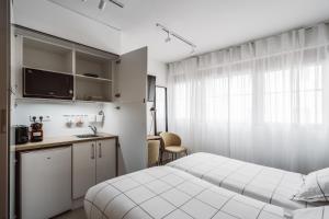 A kitchen or kitchenette at Exclusive Rooms in the Heart of the City