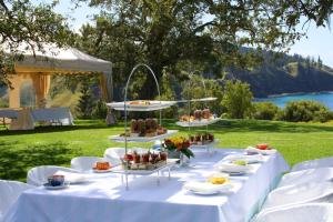 a table with several plates of food on it at Forrester Court Cliff Top Cottages in Cascade