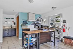 a kitchen with blue walls and a wooden counter top at Samesun Banff Hostel in Banff