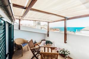 a balcony with a table and chairs and a view of the ocean at In Centro Residenza - Suites & Apartments in Vasto