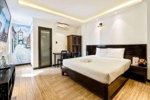 Postel nebo postele na pokoji v ubytování Lotus Laverne Hotel