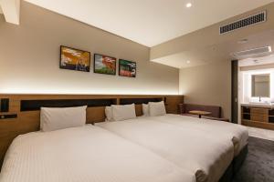 Hotel Forza Osaka Namba客房内的一张或多张床位