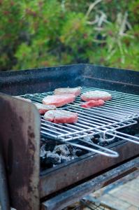 a group of meat cooking on a grill at Morro dos Anjos - authentic farmhouse with a view just 3km from Olhao in Olhão