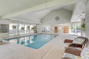 - une grande piscine dans une grande pièce avec des chaises dans l'établissement Villamare, à Île de Hilton-Head