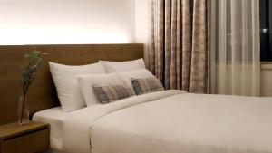 Postel nebo postele na pokoji v ubytování Bloom Hotel