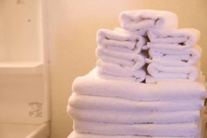 a stack of towels stacked on top of each other at ケイアイコンホテルズ 新栄901 in Nagoya +28 photos