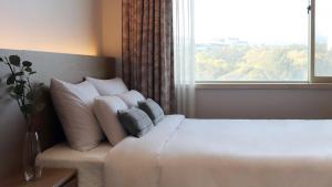 Postel nebo postele na pokoji v ubytování Bloom Hotel