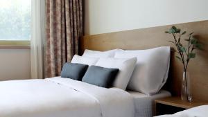 Postel nebo postele na pokoji v ubytování Bloom Hotel