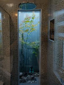 a mirror in a bathroom with a tree in it at Sailaway Beach House in Seaford