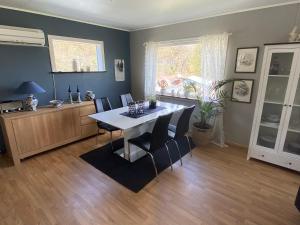 a dining room with a table and chairs at Sokndal - Cozy vacation home in peaceful surroundings in Ålgård