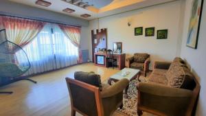 a living room with two chairs and a table at Thanh Dat Resort in Can Tho