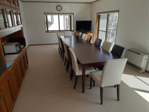 a dining room with a table and chairs at Yatsugatake Cottage in Hokuto