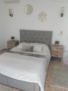 a bedroom with a large bed and two night stands at Melanos Residence 2 bdrm townhouse with private pool in Khlorakas +30 photos