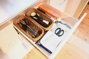 a drawer with a basket and a pair of scissors at Manabi-stay Matsue 駅近伊勢宮町どこに行くにも最高に便利な古民家一棟貸切ホテル in Matsue