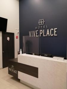 a hotelvice place with a sign on the wall at Vive Place in Aguascalientes