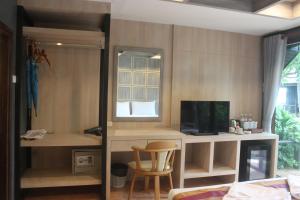 a living room with a desk and a tv at Tommy Resort - SHA Plus in Haad Rin