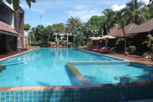 a large swimming pool with blue tiles in a resort at Tommy Resort in Haad Rin
