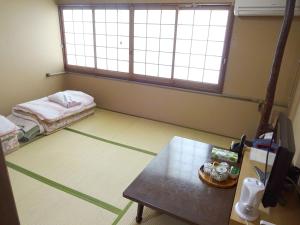 Postel nebo postele na pokoji v ubytování Imazato Ryokan