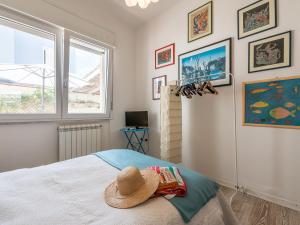 a bedroom with a bed with a hat on it at Poetto seaside in Cagliari
