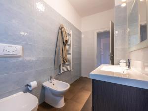 a bathroom with a white toilet and a sink at Poetto seaside in Cagliari +131 photos
