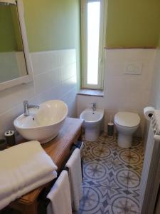 Castel GiorgioにあるCasa Bellocchioのバスルーム(洗面台2台、トイレ、鏡付)