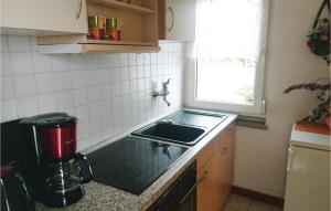 a small kitchen with a sink and a window at Nice Home In Wasungen With Wifi in Wasungen