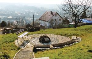 a fire pit on top of a hill with a house at Nice Home In Wasungen With Wifi in Wasungen