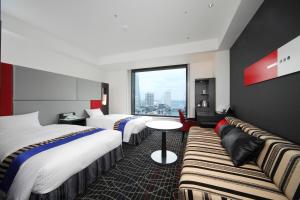 Säng eller sängar i ett rum på New Otani Inn Yokohama Premium
